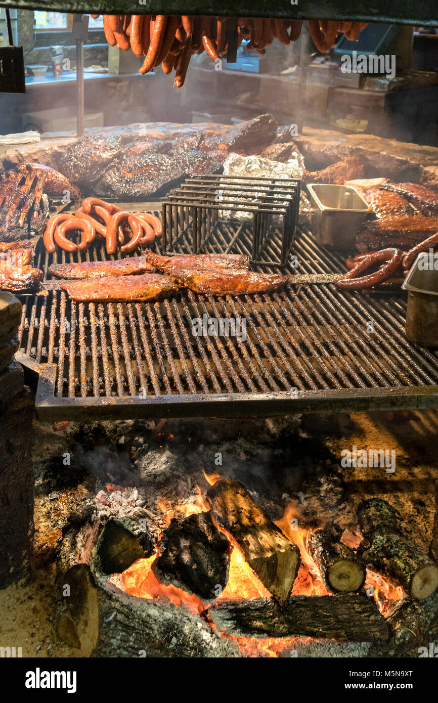 Texas style BBQ smoked over open wood flame fire pit Stock Photo Alamy