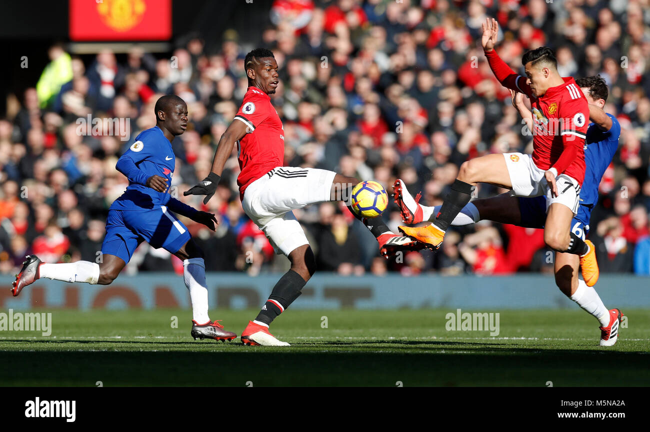 Manchester United's Paul Pogba and Alexis Sanchez challenge for the same ball with Chelsea's Danny Drinkwater (right) during the Premier League match at Old Trafford, Manchester. Stock Photo