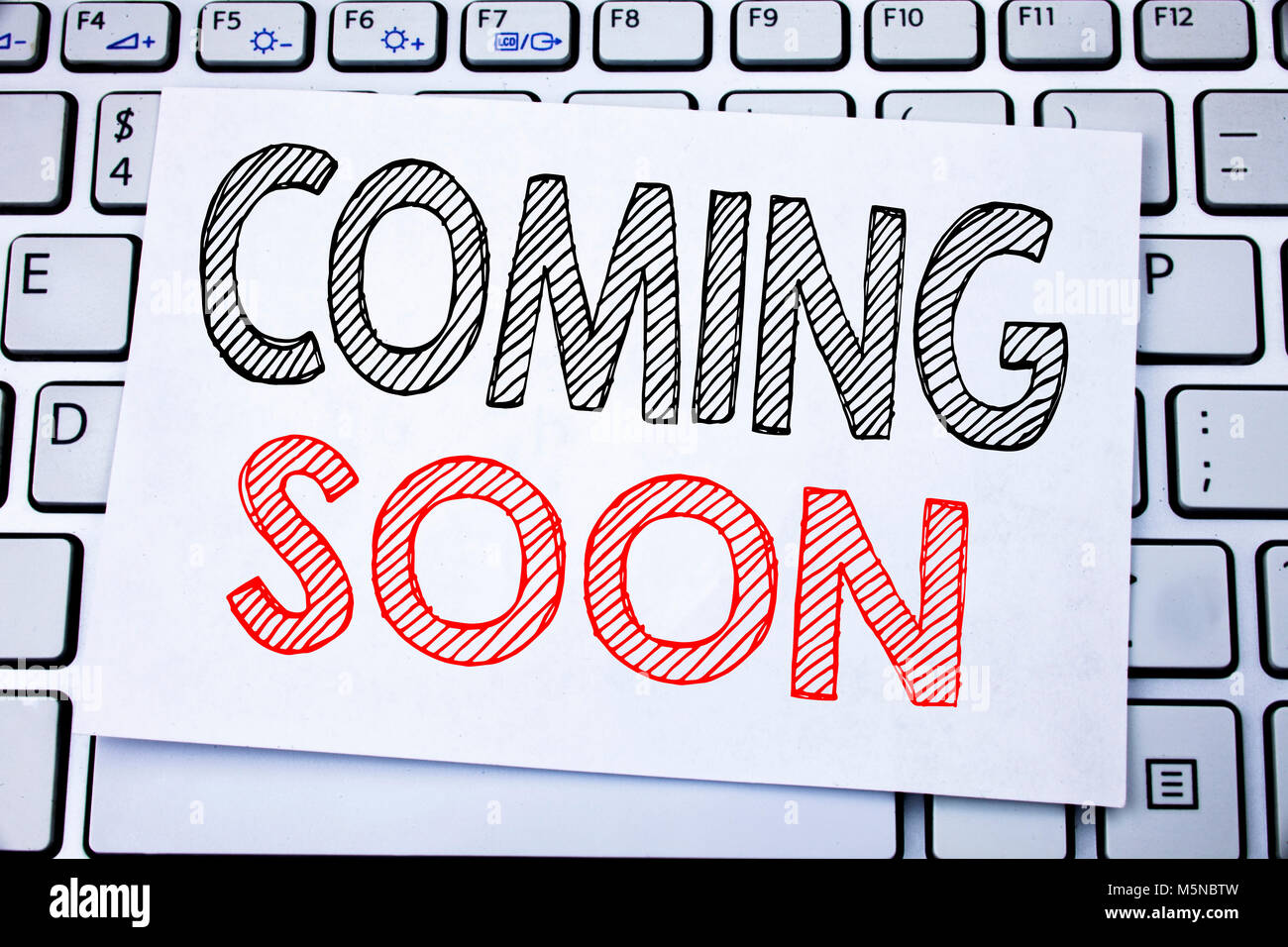 Handwritten Text Caption Showing Coming Soon Business Concept Writing For Under Construction Written On Sticky Note Paper On White Keyboard Backgroun Stock Photo Alamy