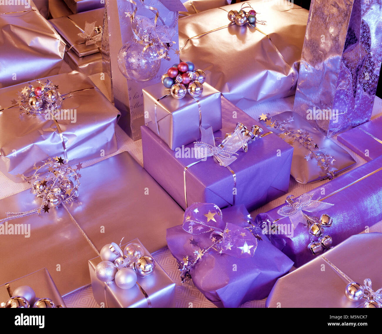 An brightly colored assortment of gift wrapped Christmas parcels. Stock Photo