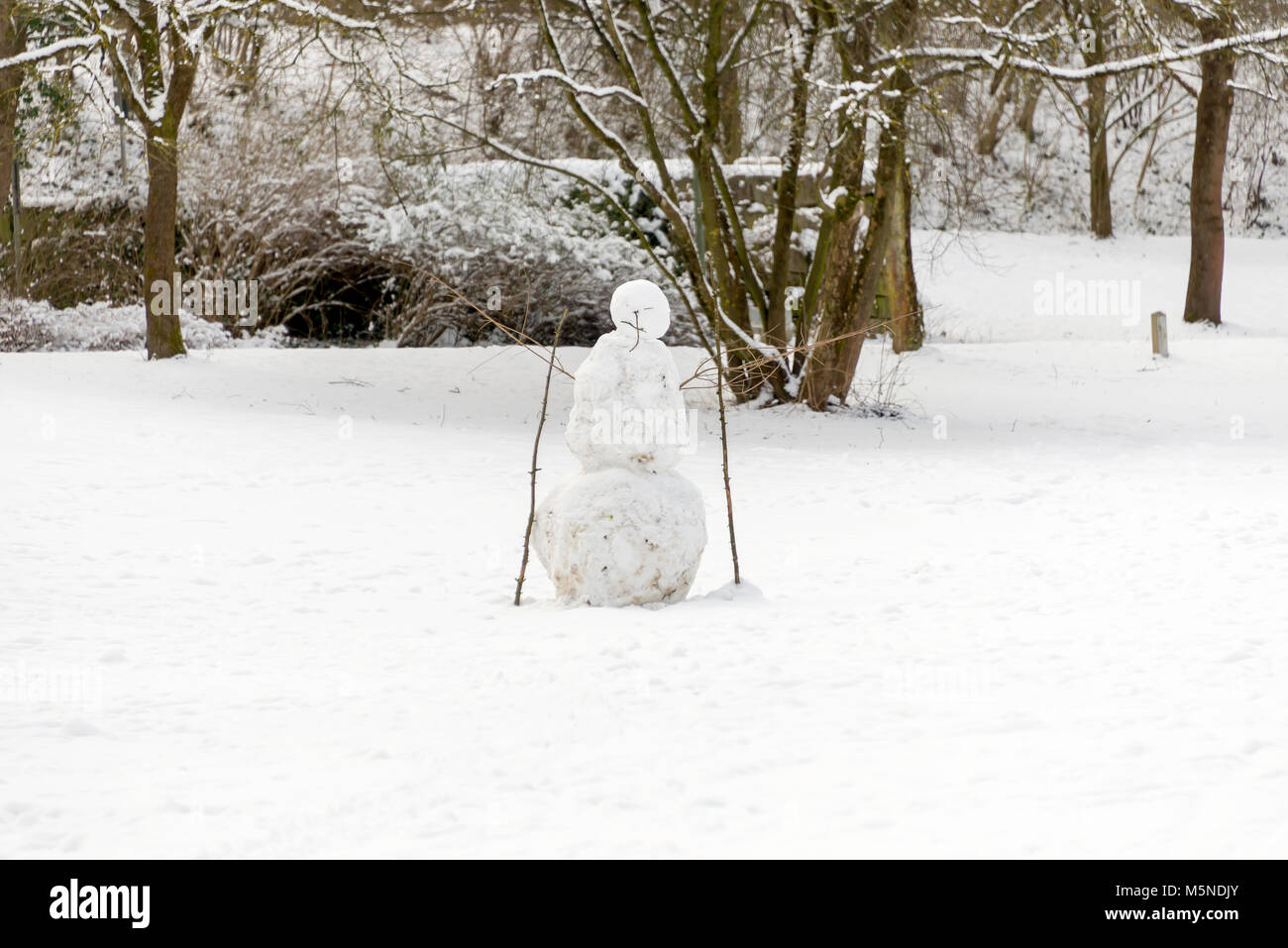 Snow man angry with stones during winter season Stock Photo
