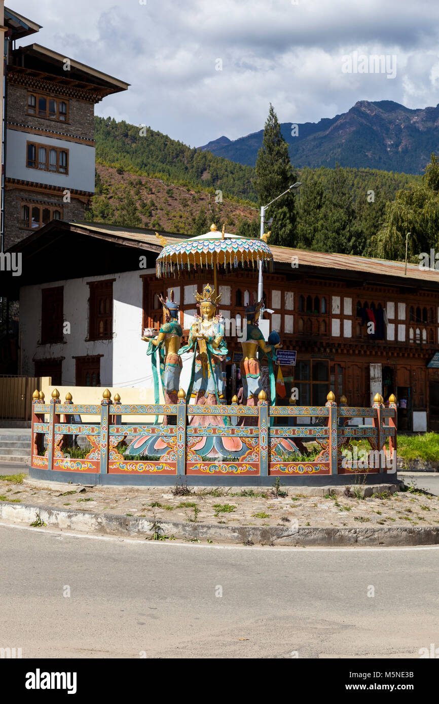 Thimphu, Bhutan.  Traffic Roundabout with Buddhist Gods of Prosperity and Wealth. Stock Photo