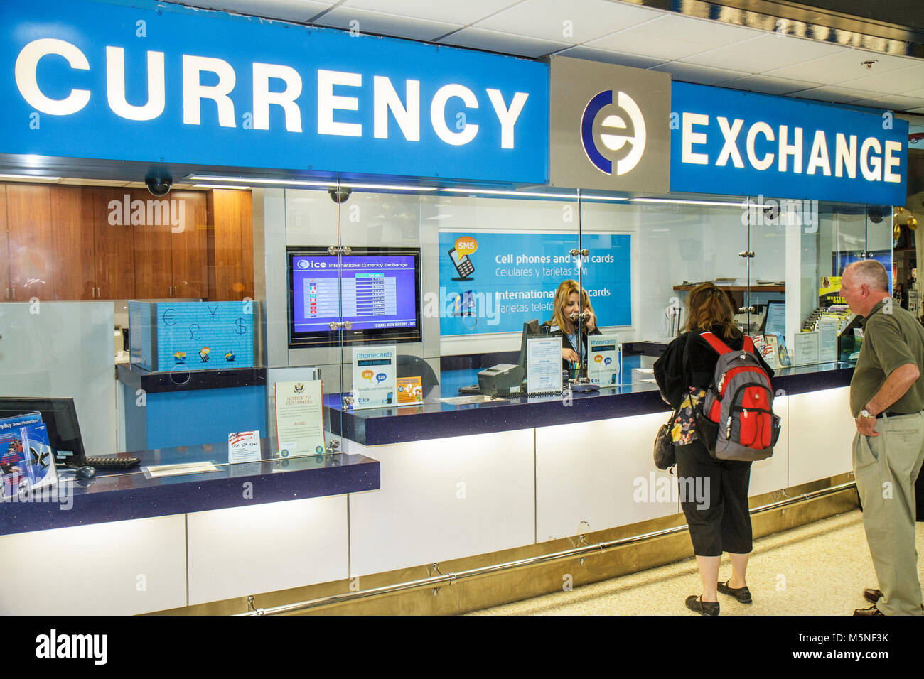 Miami Florida International Airport MIA,foreign exchange brokers,currency,man men male,woman female women,currency,money,cashier,counter,security glas Stock Photo