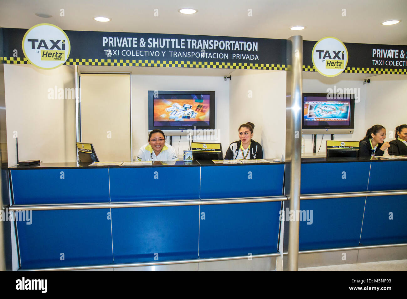 Cancun Mexico,Mexican,Cancun International Airport,Hispanic ethnic woman female women,ground transportation,taxi,taxis,shuttle,counter,Hispanic ethnic Stock Photo