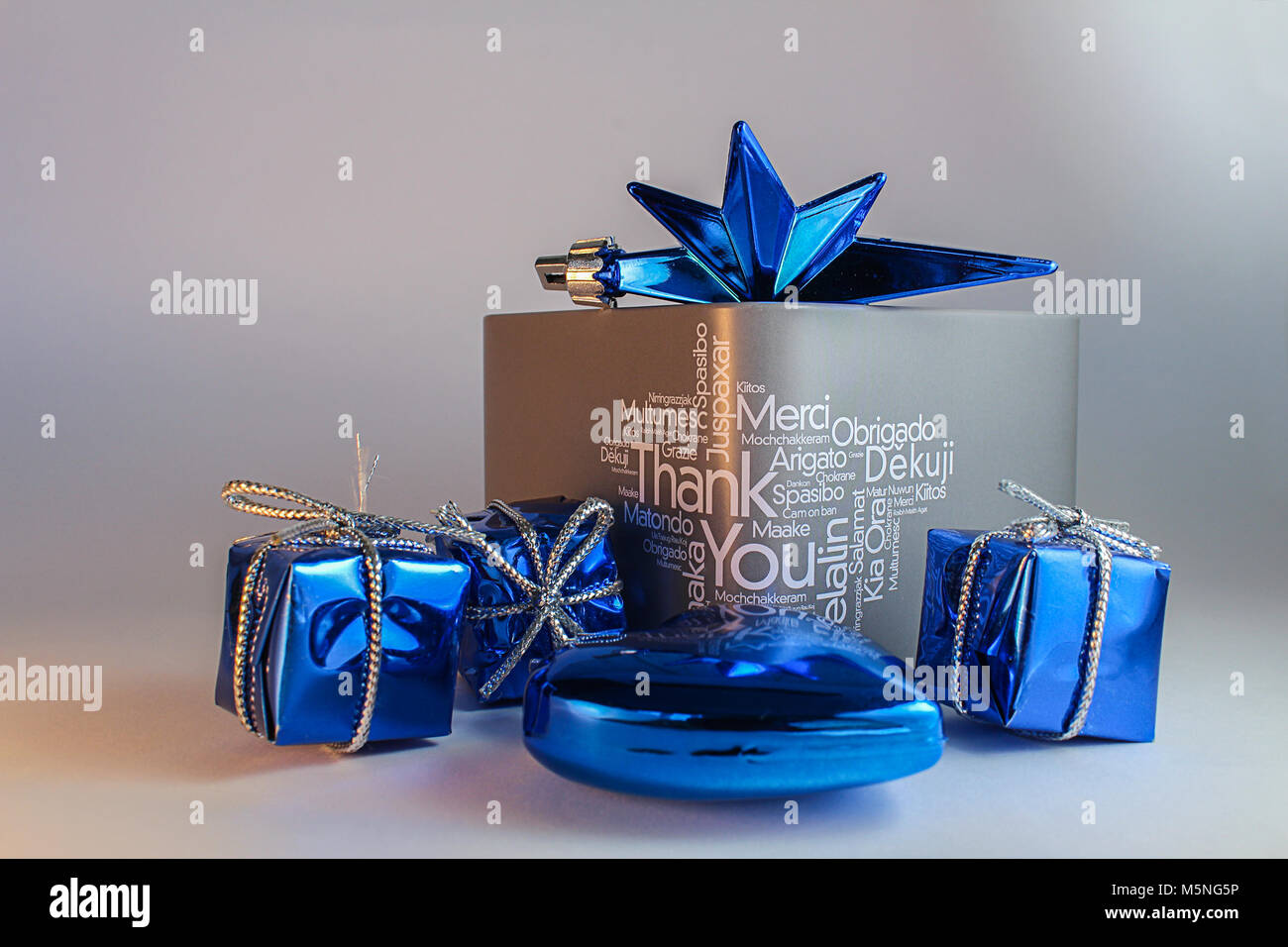 Grey gift box with text and blue decoration Stock Photo - Alamy