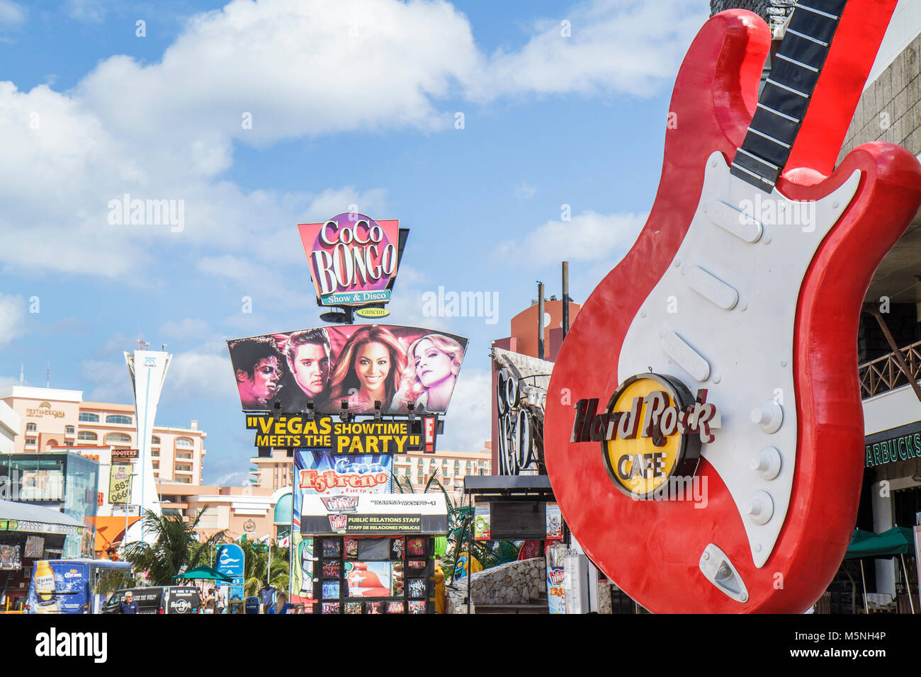Cancun Mexico,Mexican Beach,Hotel Zone,Avenida Kukulkan,Plaza Forum,district,street scene,Hard Rock Cafe,guitar sign,Coco Bongo,billboard,advertisemen Stock Photo