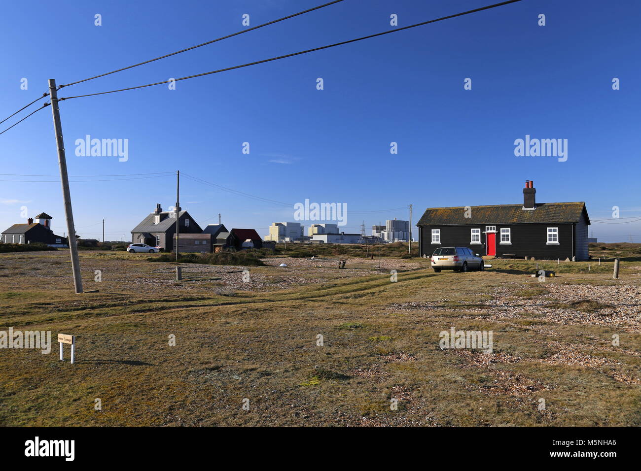 Private residences with Nuclear Power Station beyond. Dungeness, Kent, England, Great Britain, United Kingdom, UK, Europe Stock Photo