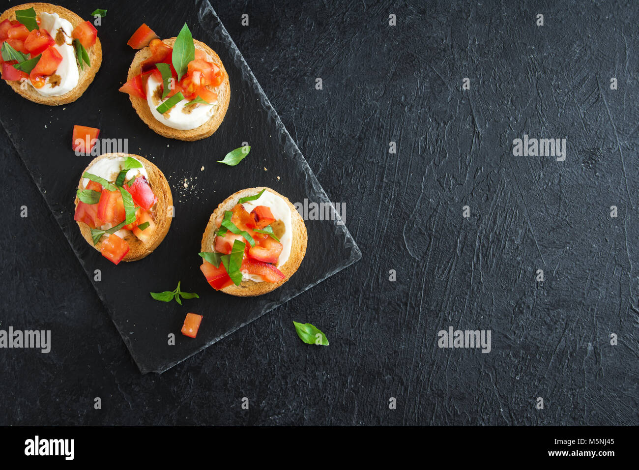 Italian bruschetta with chopped tomatoes, basil, mozzarella cheese and