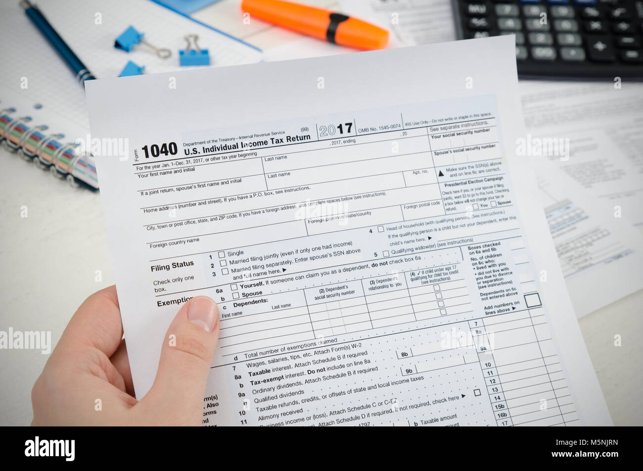 Man filling US tax form. tax form us business income office hand fill ...