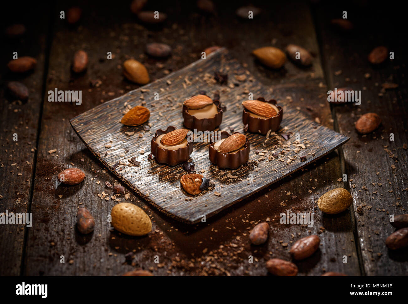 Nougat cream with an almond in very thin-sliced dark chocolate Stock Photo