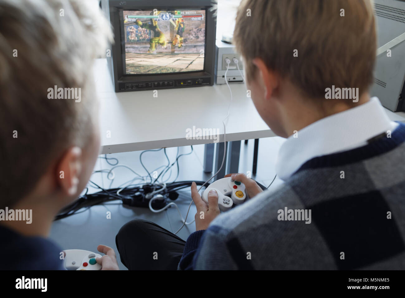 St. Petersburg, Russia - February 22, 2018: People playing with retro video game consoles on the exhibition of retro computers during St. Petersburg C Stock Photo