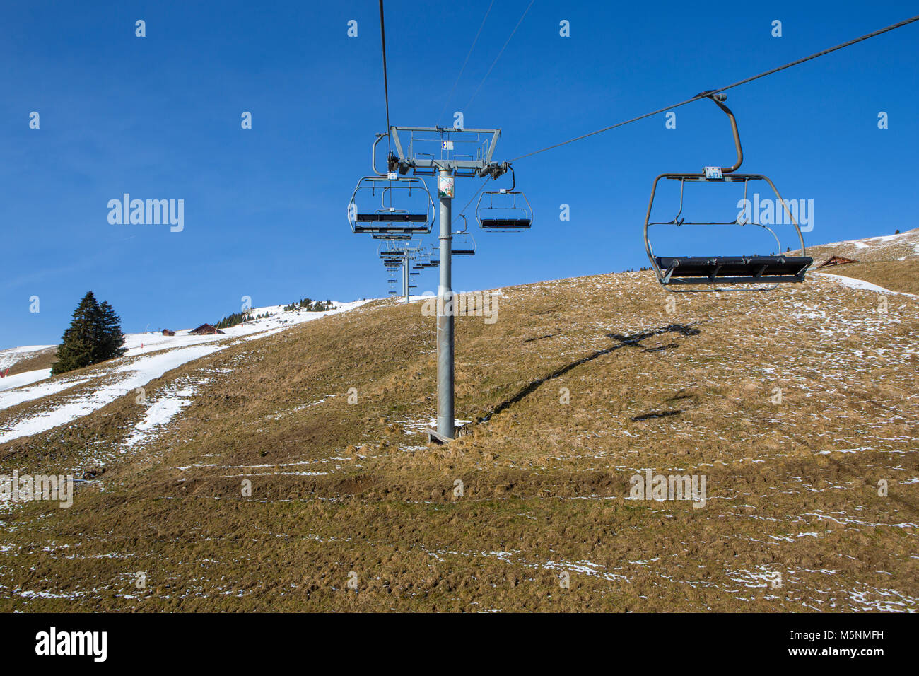 Sparse Snow Swiss ski lift with sparse snow Stock Photo - Alamy