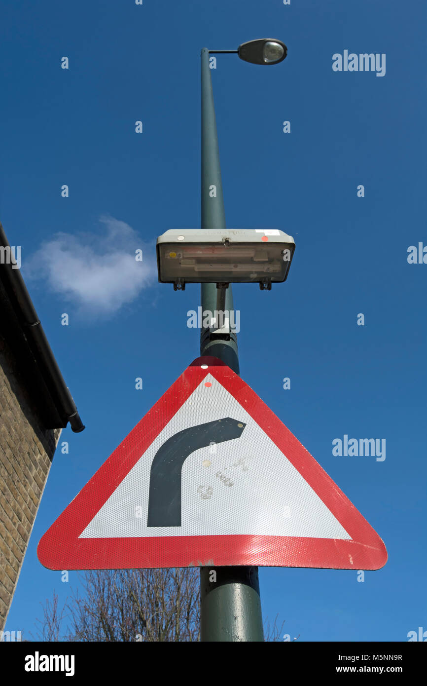 british road sign warning of a right hand bend Stock Photo