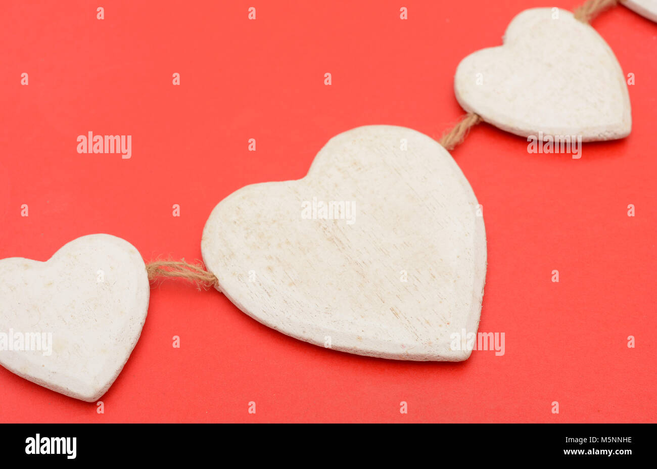 Closeup of Heart wooden shape on red background Stock Photo - Alamy