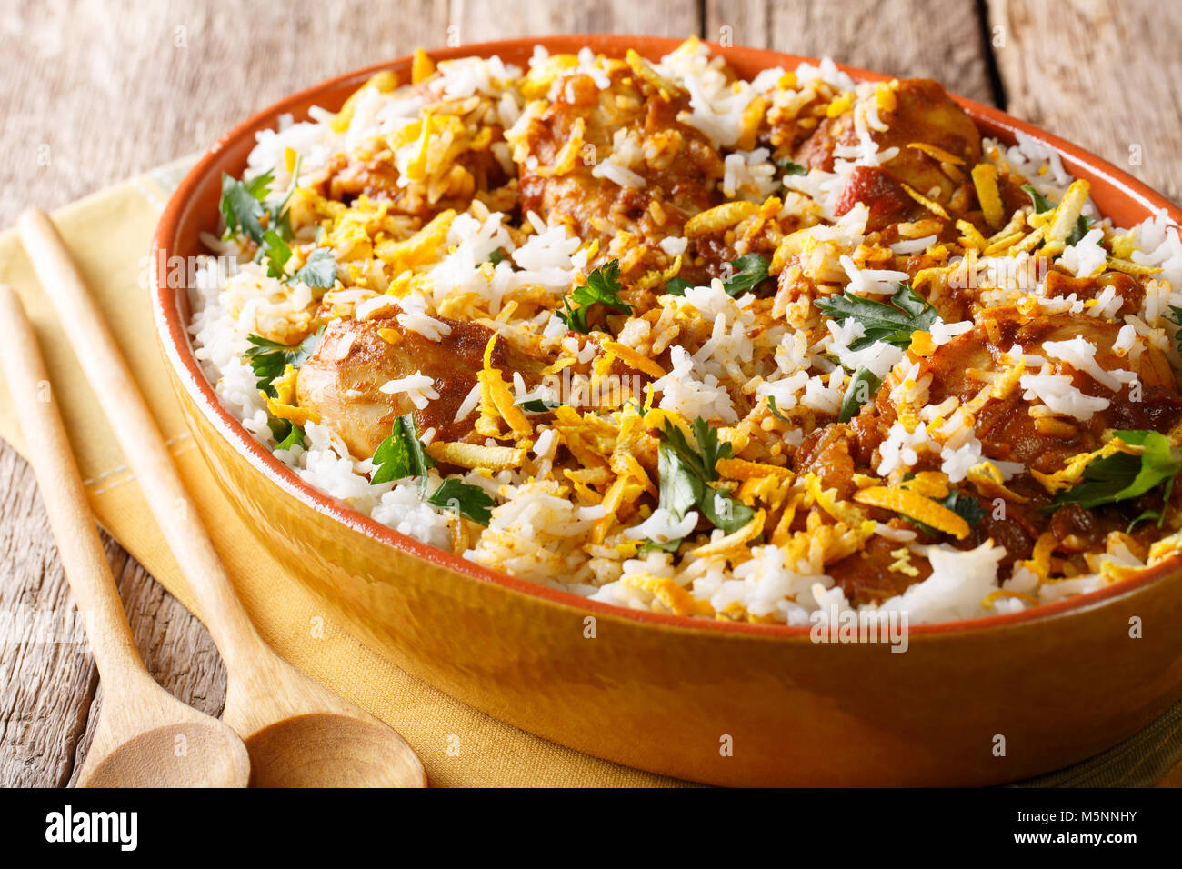 Indian pilaf biryani with chicken, onion, lemon, spices and cilantro