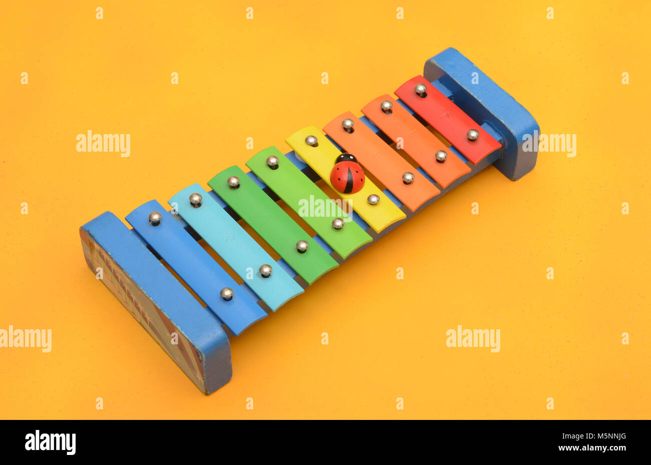 xylophone children music playing ornament yellow background Stock Photo Alamy