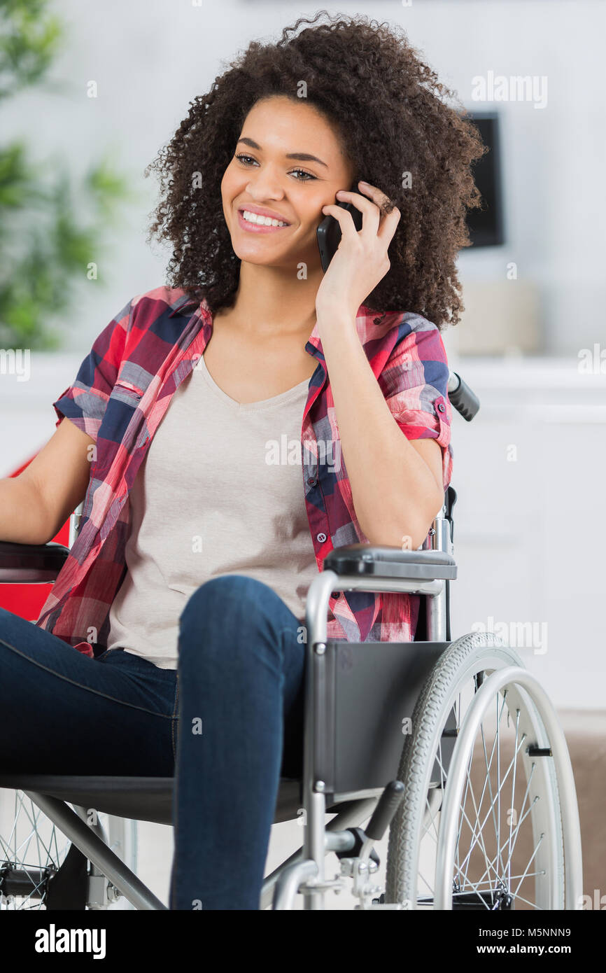 Young woman in wheelchair using cellphone Stock Photo - Alamy