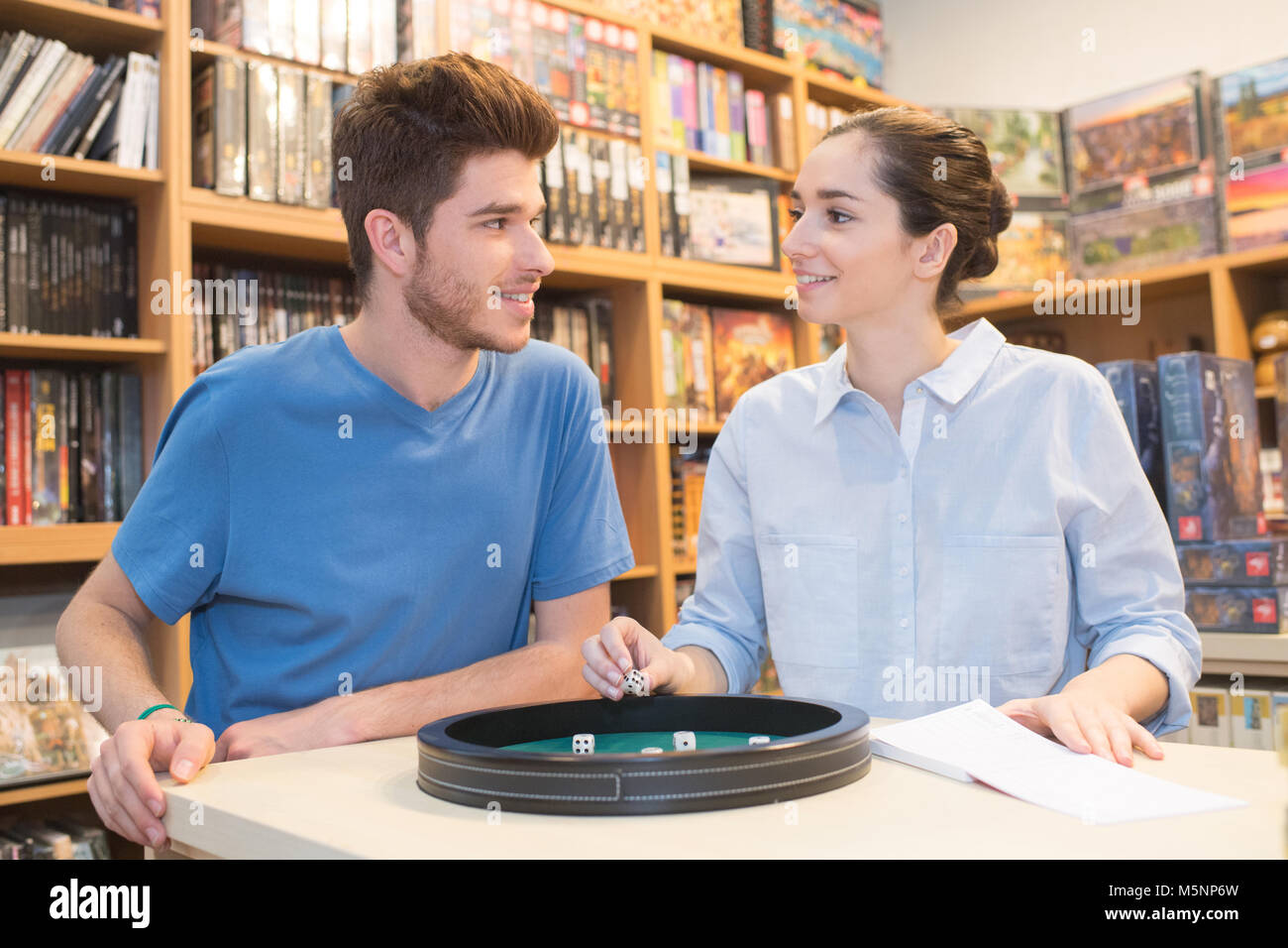 couple in love playing ludo board game at a store Stock Photo