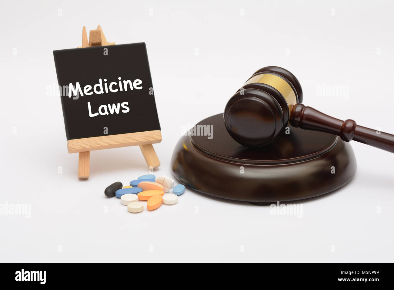 Medicine Law with tablets and gavel on white background Stock Photo