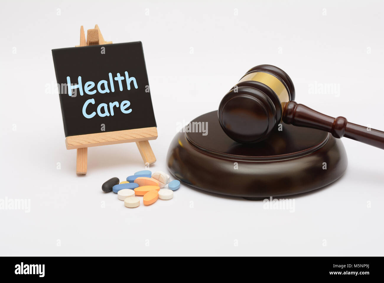 Healthcare law with medicine tablet and gavel Stock Photo
