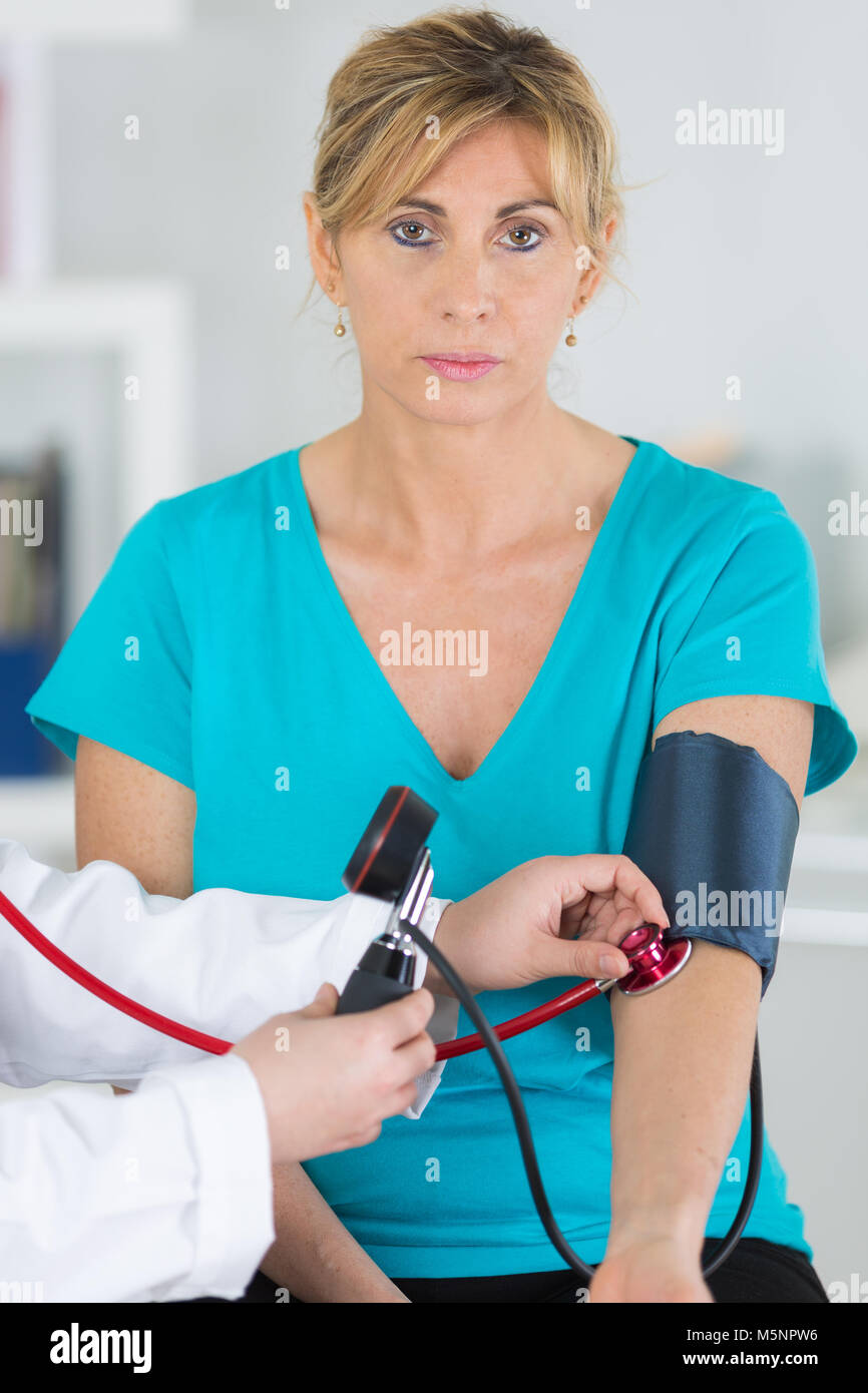 Middle aged lady having blood pressure test Stock Photo Alamy