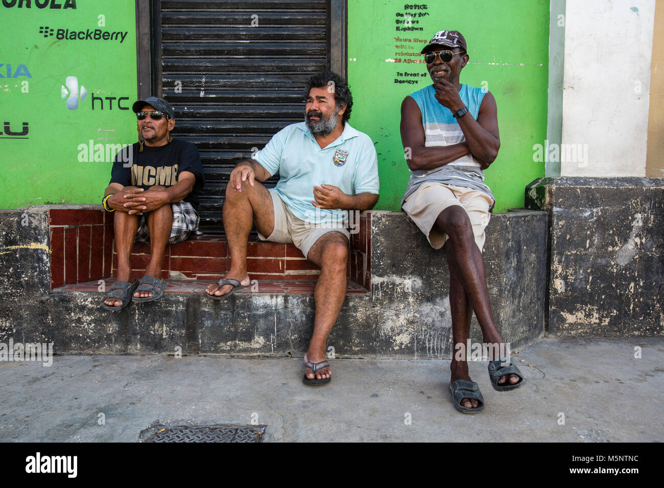 Locals hanging out in Belize City near the Swing Bridge Stock Photo