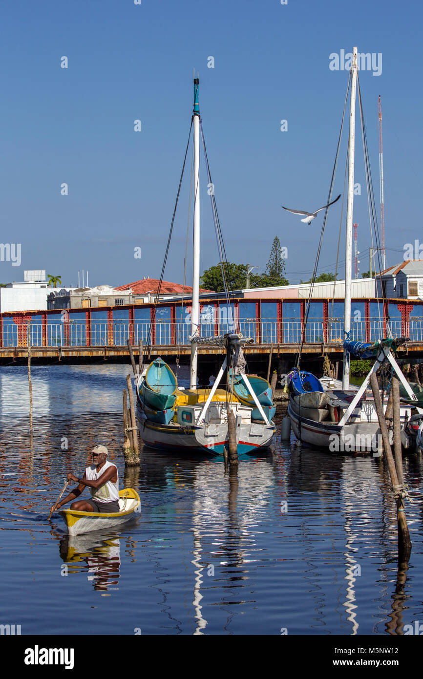 Man paddling in Haulover Creek at the Belize City Swing Bridge Stock Photo