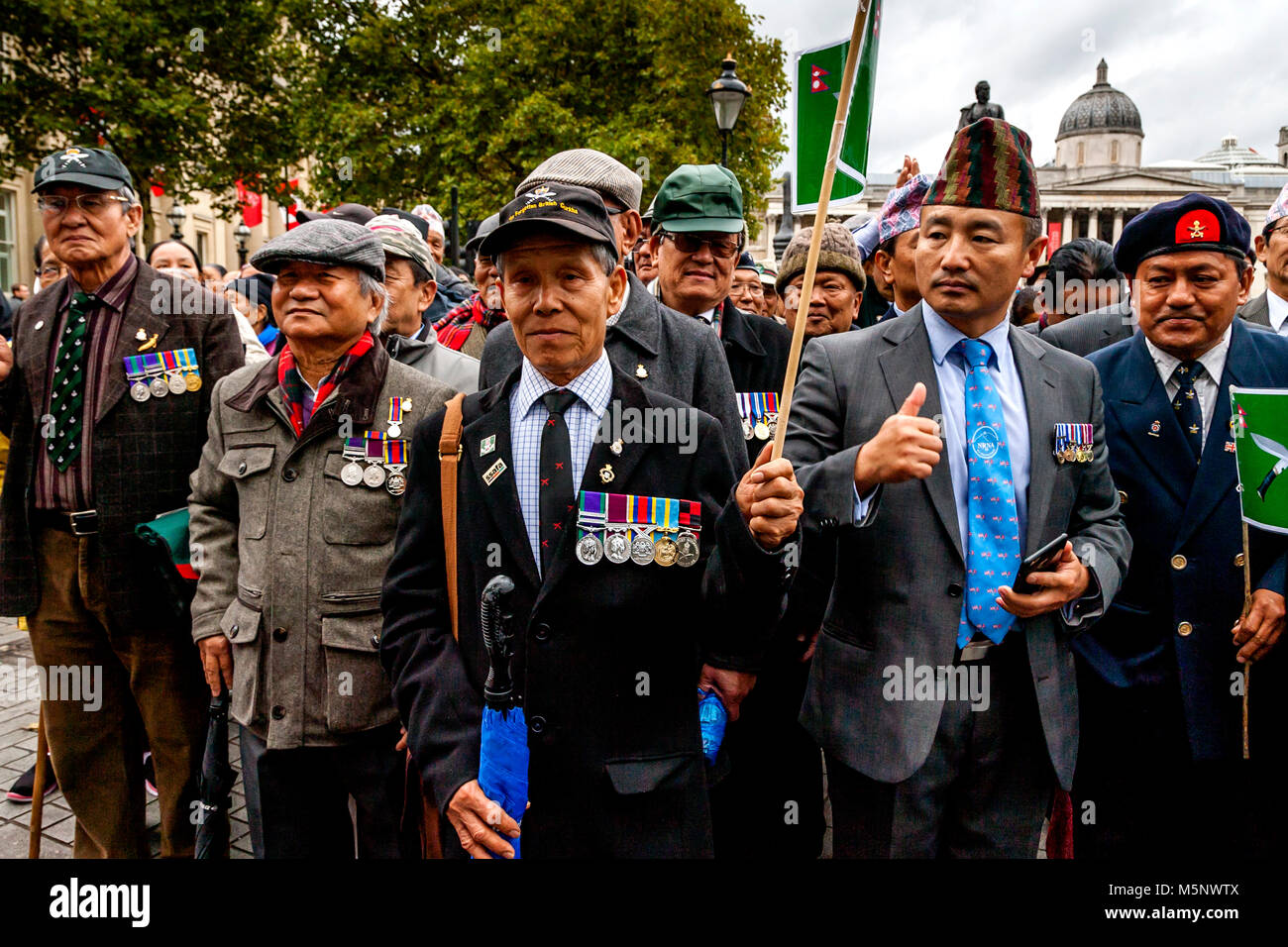 Former Ghurka soldiers stand in support of football fans from across the Uk who are marching against extremism under the banner of the FLA, London, UK Stock Photo