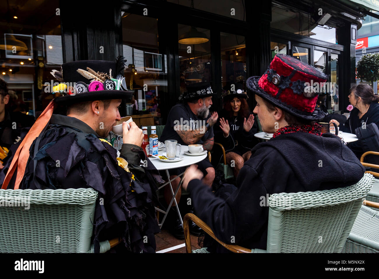 A Group Of Morris Dancers Drinking Coffee In A Cafe Before Performing