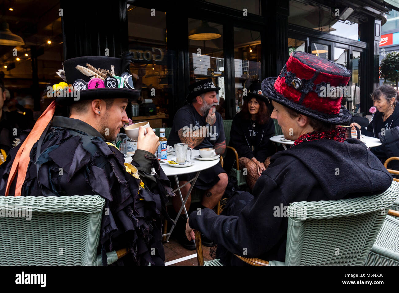 A Group Of Morris Dancers Drinking Coffee In A Cafe Before Performing