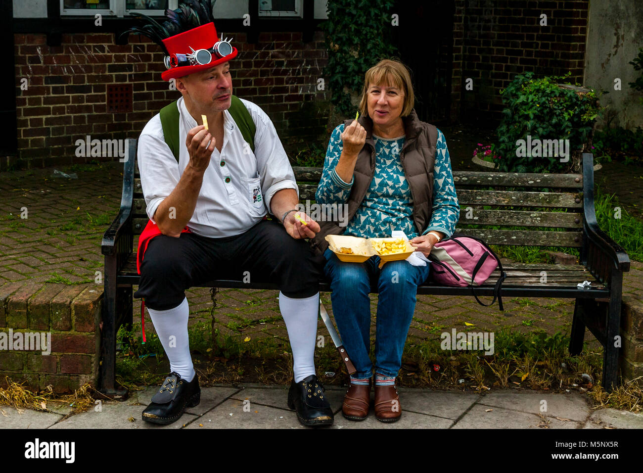 A Couple Eating Fish and Chips During The Annual Lewes Folk Festival, Lewes, Sussex, UK Stock Photo