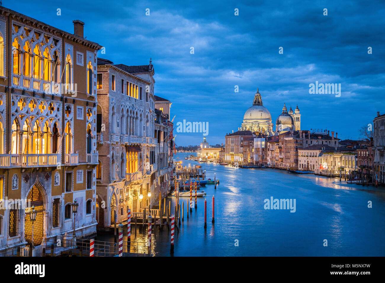 Classic view of famous Canal Grande with historic Basilica di Santa Maria della Salute in the background in twilight, Venice, Italy Stock Photo