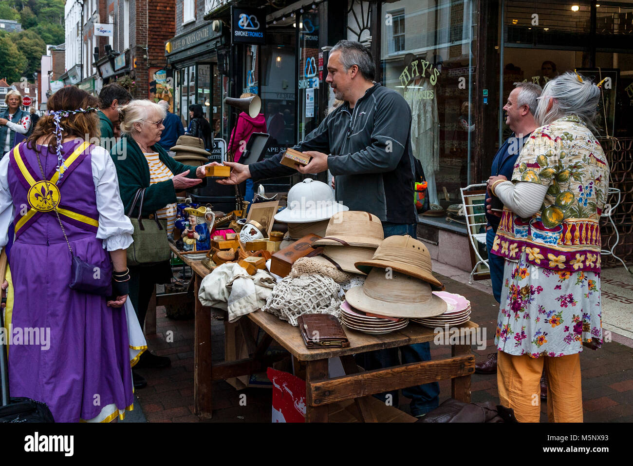 People Browsing and Buying Items From A Bric A Brac Stall, High Street, Lewes, Sussex, UK Stock Photo