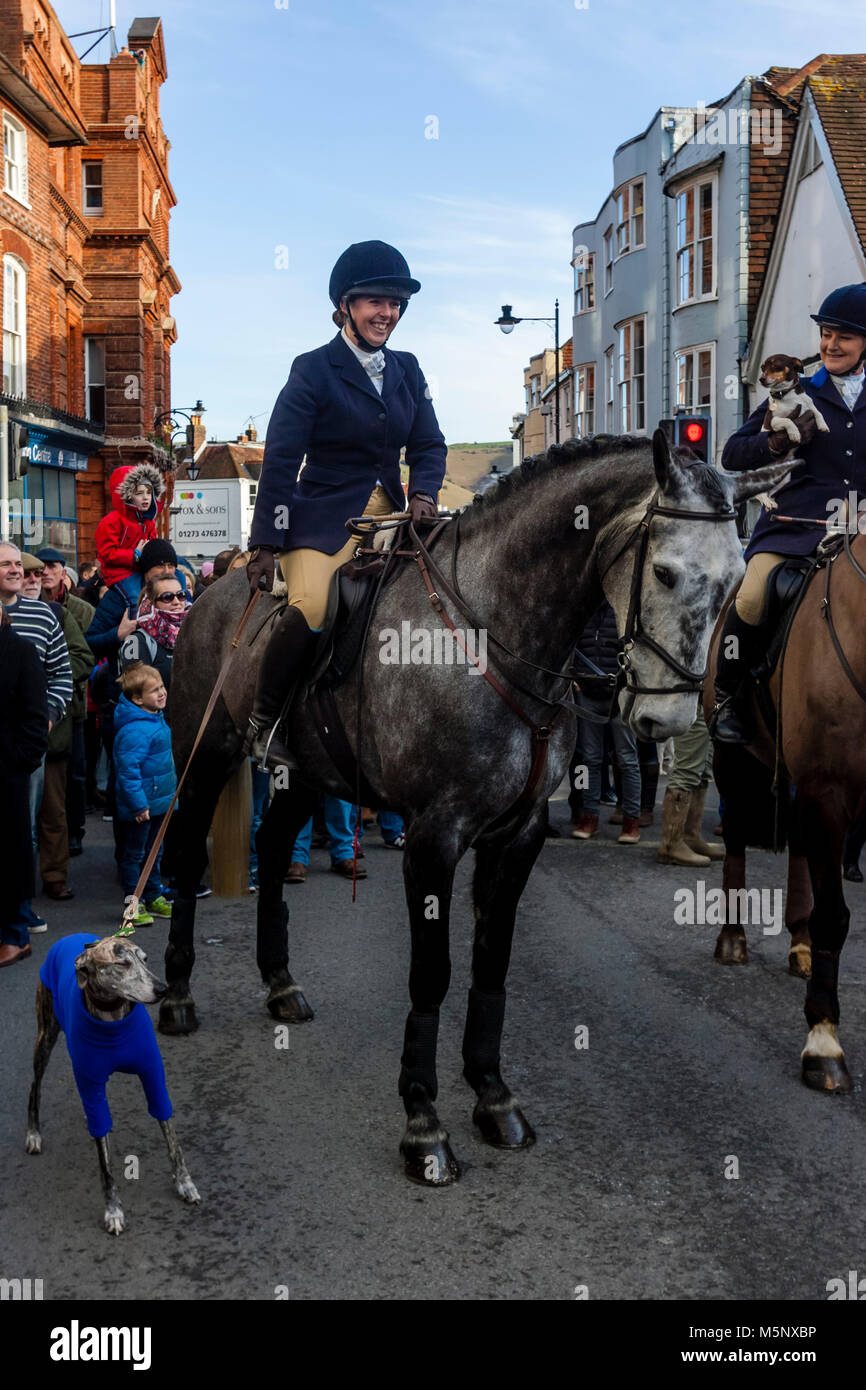 Hunt Members Holding On To A Pet Dog At The Southdown and Eridge Hunt’s Traditional Boxing Day Meeting, High Street, Lewes, Sussex, UK Stock Photo