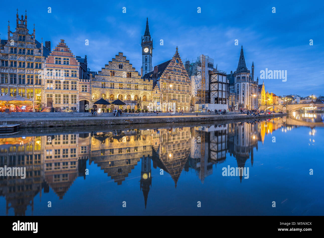 Panoramic view of famous Graslei in the historic city center of Ghent illuminated at night with Leie river, Flanders region, Belgium Stock Photo