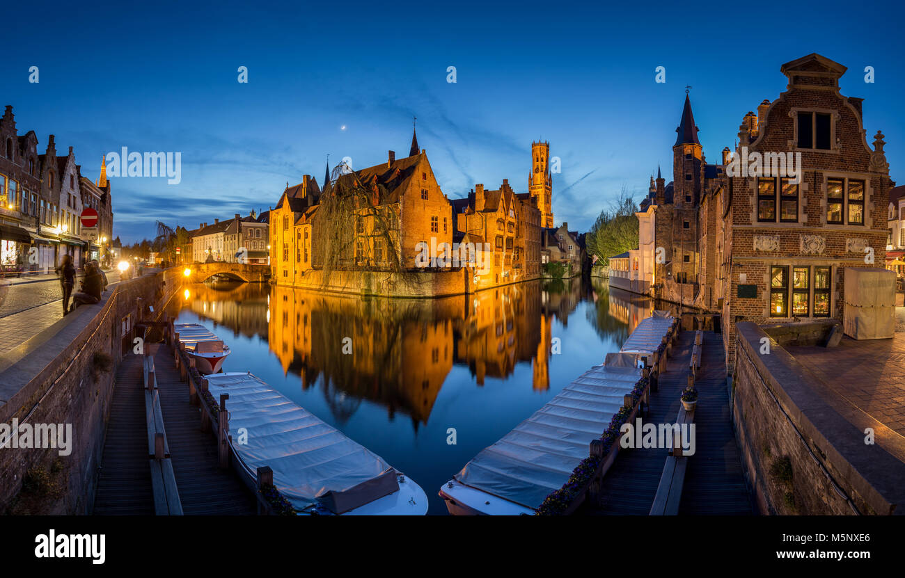 Hstoric city center of Brugge, often referred to as The Venice of the North, with famous Rozenhoedkaai illuminated in twilight, Flanders, Belgium Stock Photo