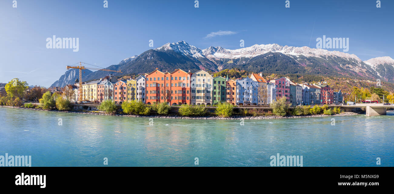 Innsbruck city panorama with colorful houses along Inn river and famous Austrian mountain summits in the background in summer, Tyrol, Austria Stock Photo