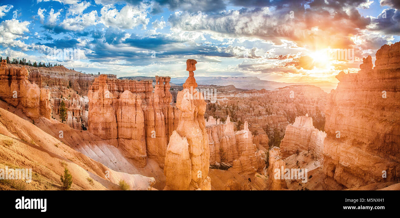 Amazing hoodoos sandstone formations in Bryce Canyon National Park in golden morning light at sunrise with dramatic clouds, Utah, American Southwest Stock Photo