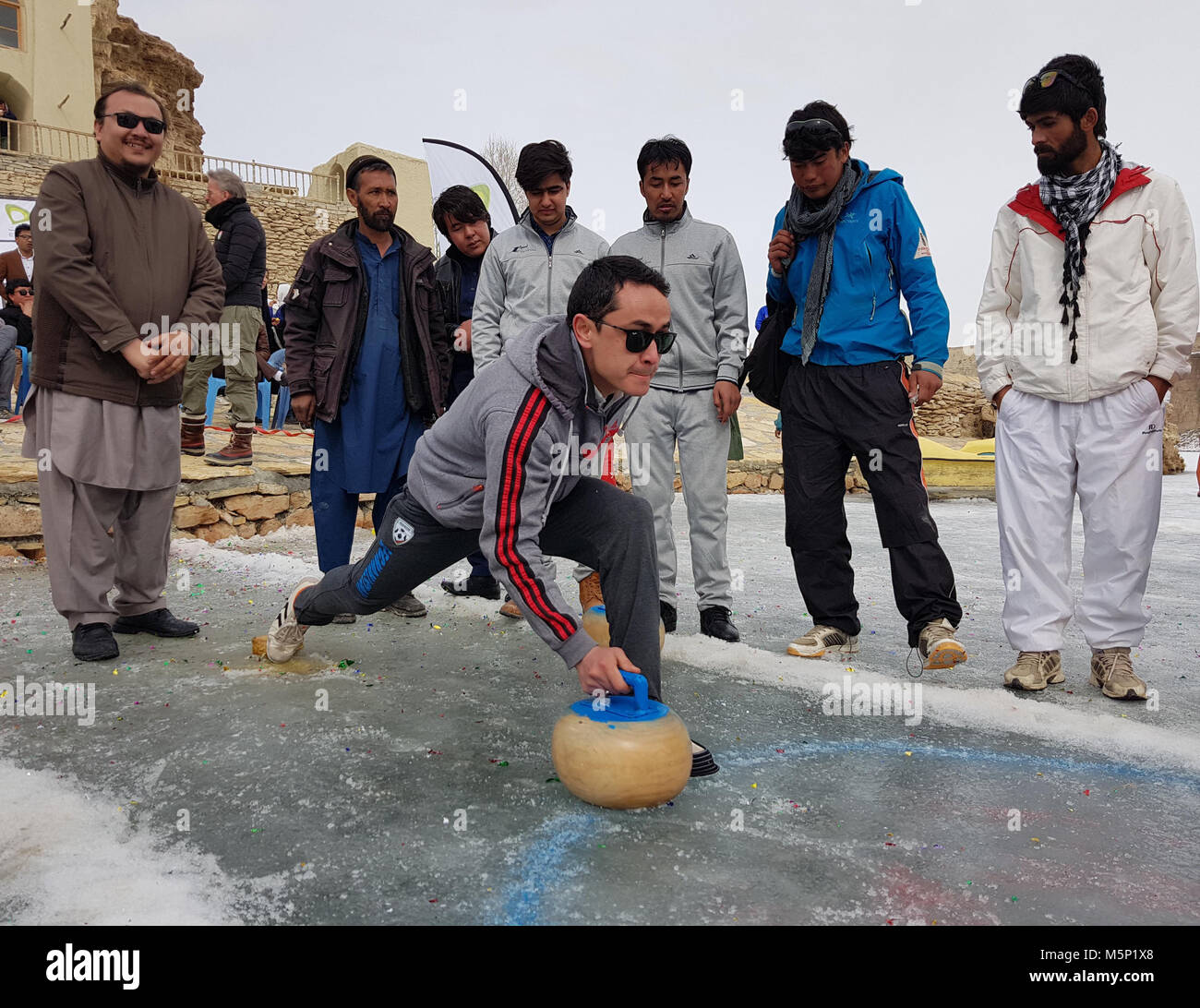 (180225) -- BAMYAN, Feb. 25 (Xinhua) -- A man plays curling during a winter game festival in Bamyan province, Afghanistan, Feb. 23. 2018. Stock Photo