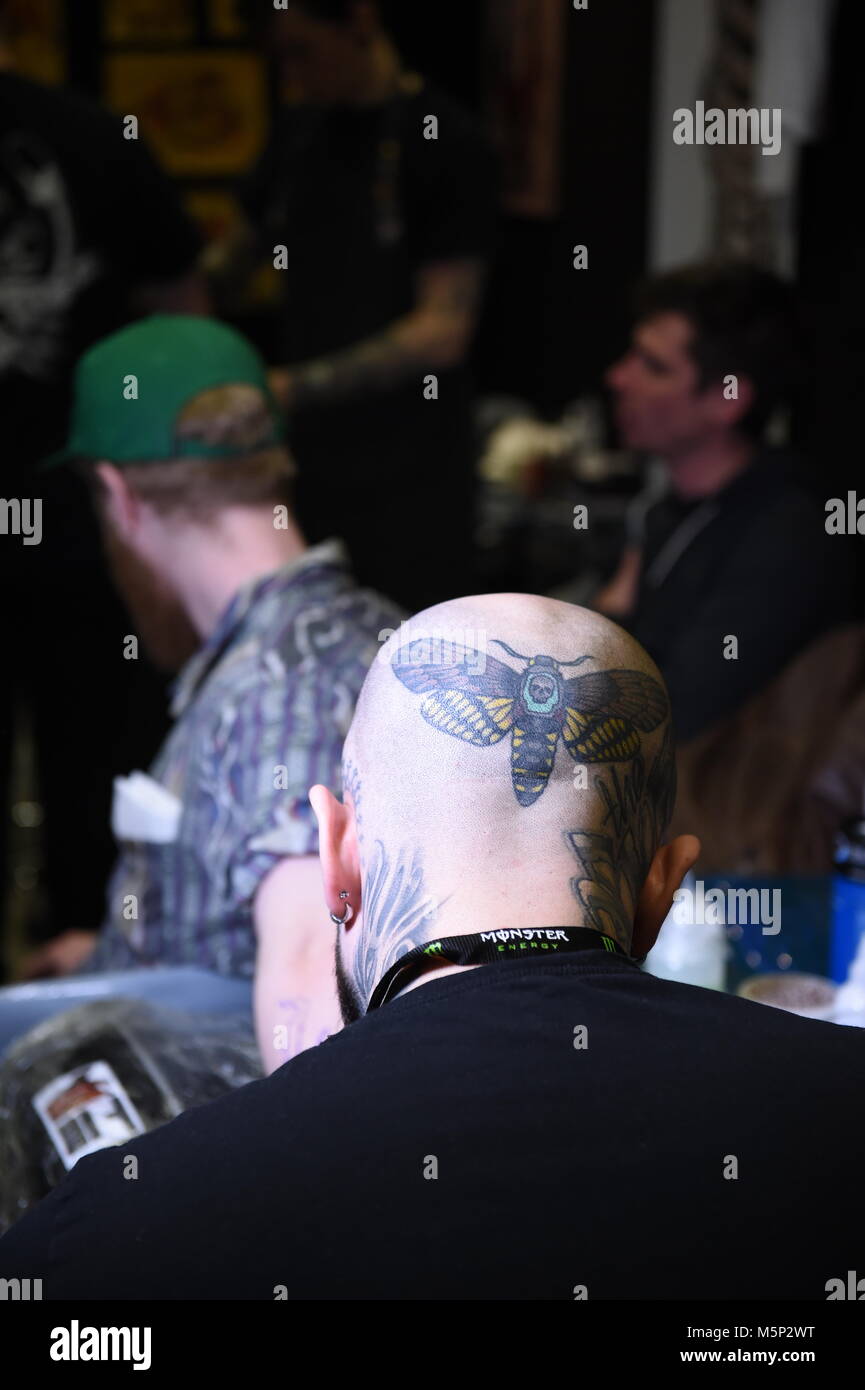 Brighton UK 25th February 2018 - Tattooists at work at the 11th annual Brighton Tattoo Convention held in the Brighton Centre over the weekend attracting tattoo artists from all over the world Photograph taken by Simon Dack Credit: Simon Dack/Alamy Live News Stock Photo