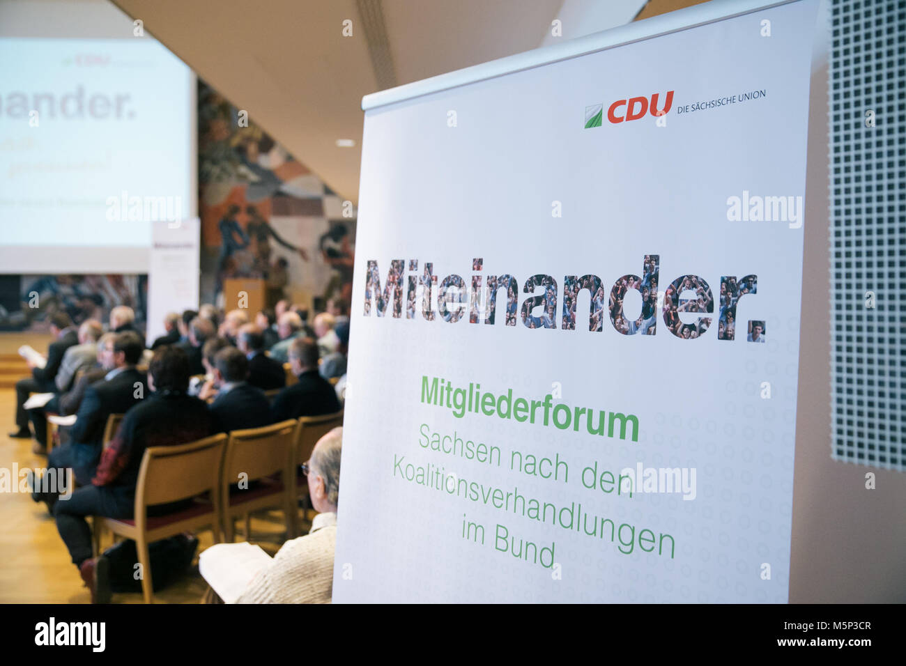 24 February 2018, Germany, Dresden: A sign reading 'Miteinander' (lit. 'together') can be seen during the member forum of the Saxonian CDU regarding the coalition agreements. Photo: Oliver Killig/dpa-Zentralbild/dpa Stock Photo