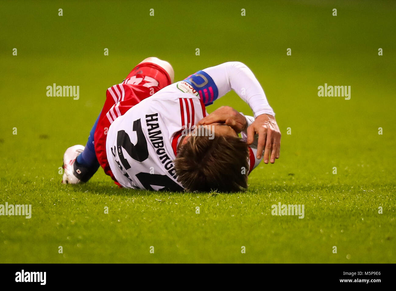 24 Febuary 2018, Germany, Bremen, German Bundesliga soccer match between Werder Bremen and Hamburger SV, Weserstadion: Hamburg's Gotoku Sakai lies on the grass. Photo: Christian Charisius/dpa - Nutzung nur nach vertraglicher Vereinbarung Stock Photo