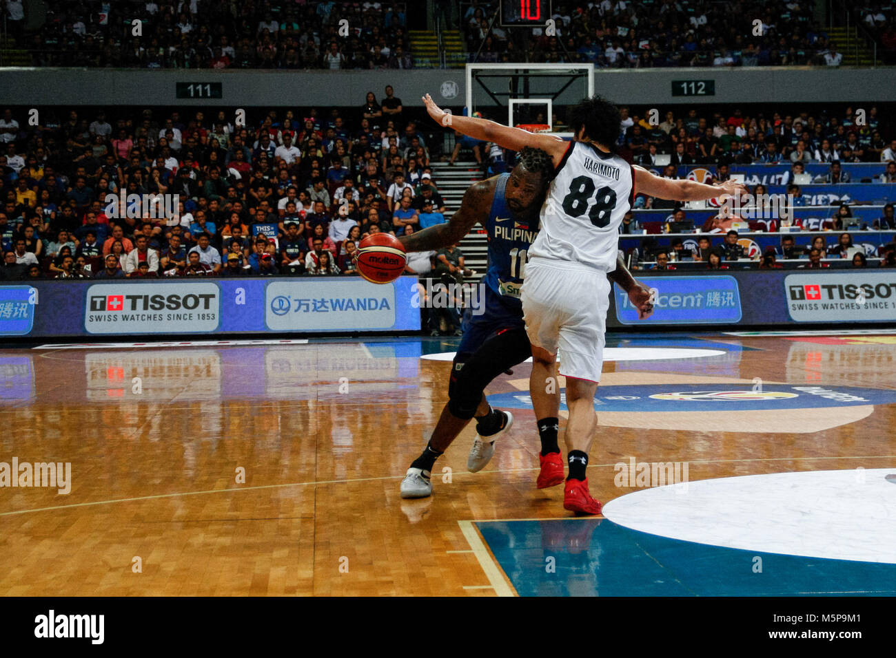 Philippines. 25th Feb, 2018. Andray Blatche (11) makes his way against Tenketsu Harimoto (88) during the qualifying game at the MOA Arena. The Philippine and Japanese basketball team met at the hardcourt of the Mall of Asia Arena in Pasay City, for the FIBA World Cup 2019 Asian Qualifiers. The Philippines won over Japan, 89-84. Credit: J Gerard Seguia/ZUMA Wire/Alamy Live News Stock Photo