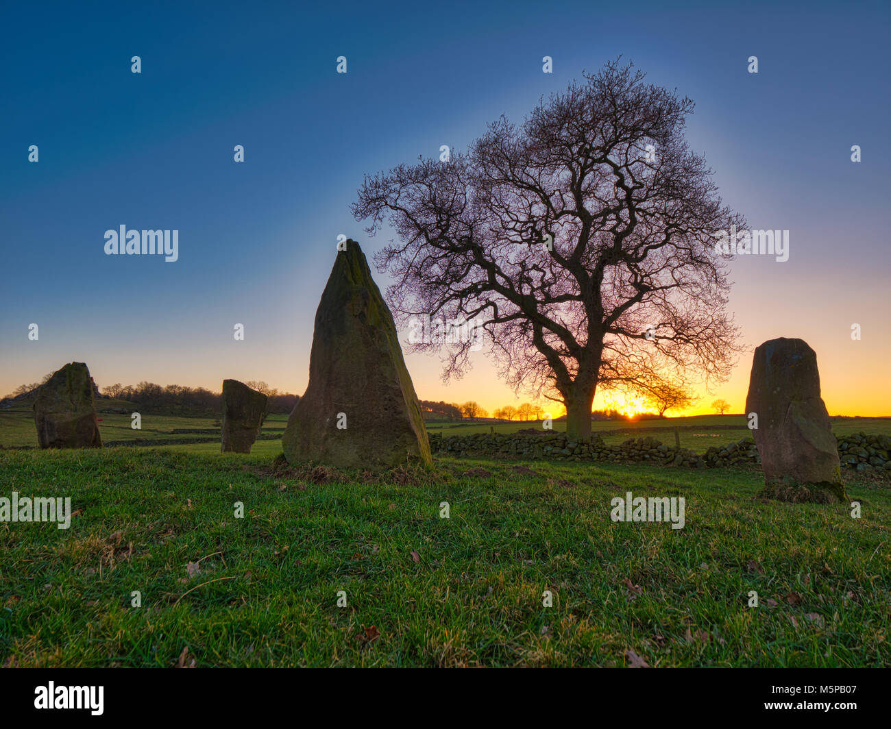 Peak District, Derbyshire, UK. 25th February, 2018. UK Weather spectacular sunset on a bitterly cold day at The Grey Ladies / Nine Stone Close Stone Circle, Robin Hood’s Stride near Elton, Alport & Birchover south of Bakewell in the Peak District National Park, Derbyshire, UK Credit: Doug Blane/Alamy Live News Stock Photo