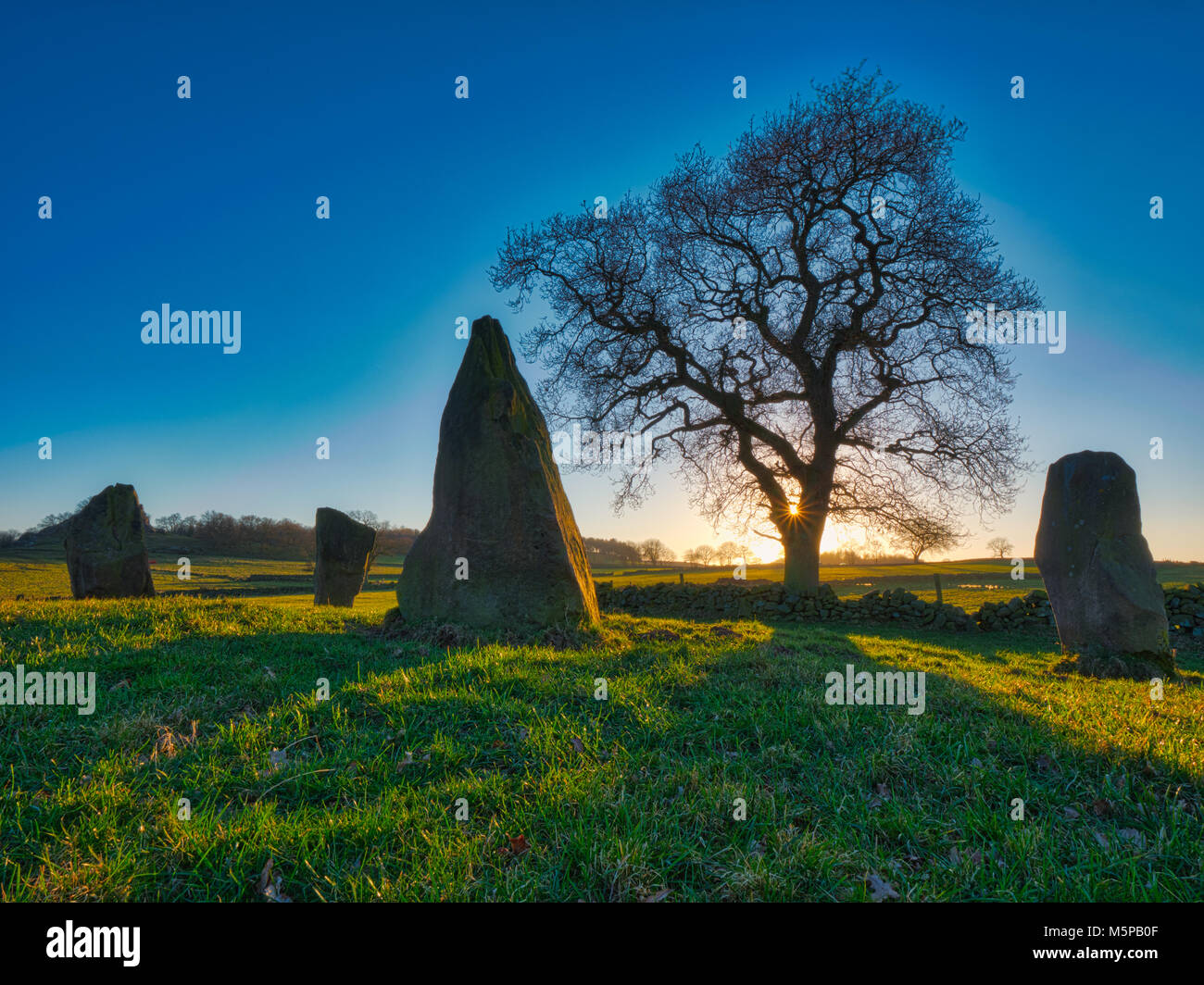 Peak District, Derbyshire, UK. 25th February, 2018. UK Weather spectacular sunset on a bitterly cold day at The Grey Ladies / Nine Stone Close Stone Circle, Robin Hood’s Stride near Elton, Alport & Birchover south of Bakewell in the Peak District National Park, Derbyshire, UK Credit: Doug Blane/Alamy Live News Stock Photo