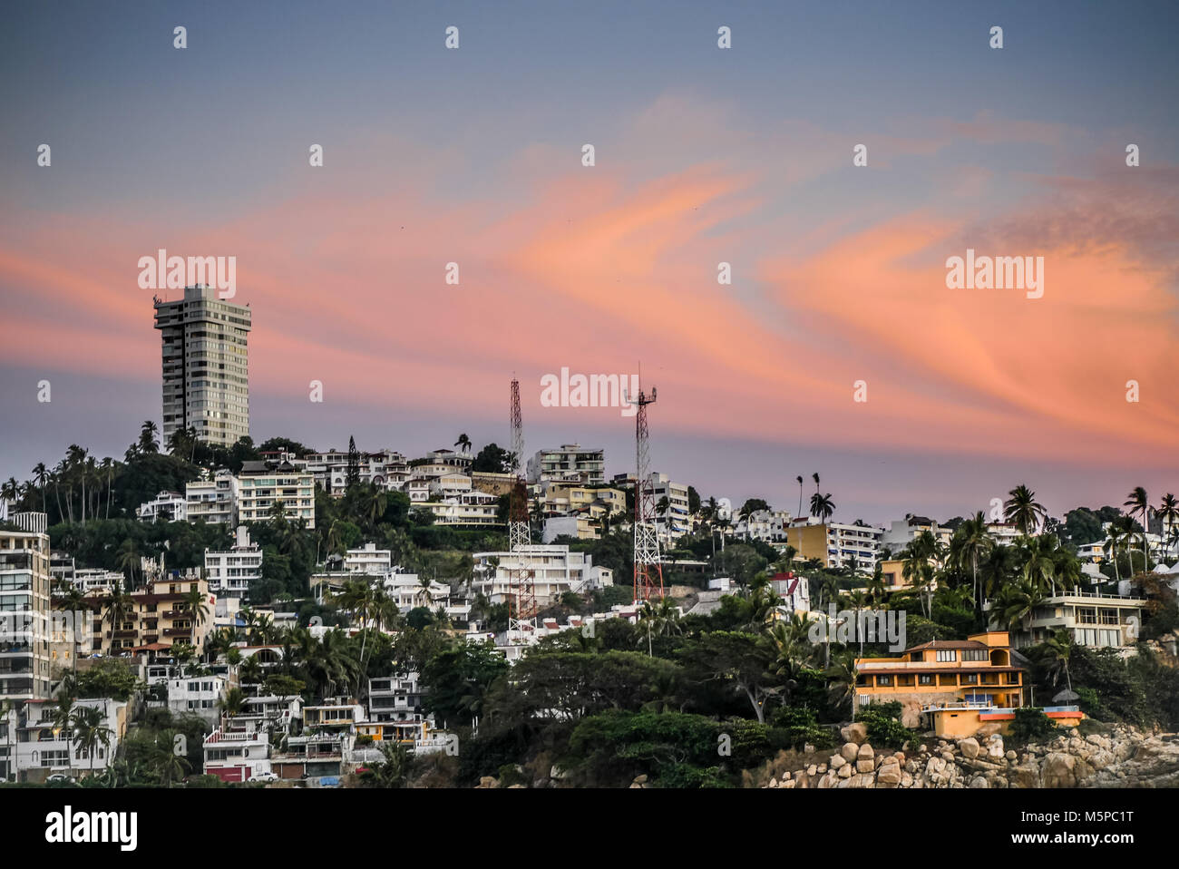 View of Acapulco neighborhood on a cliff with hotels and houses. Stock Photo