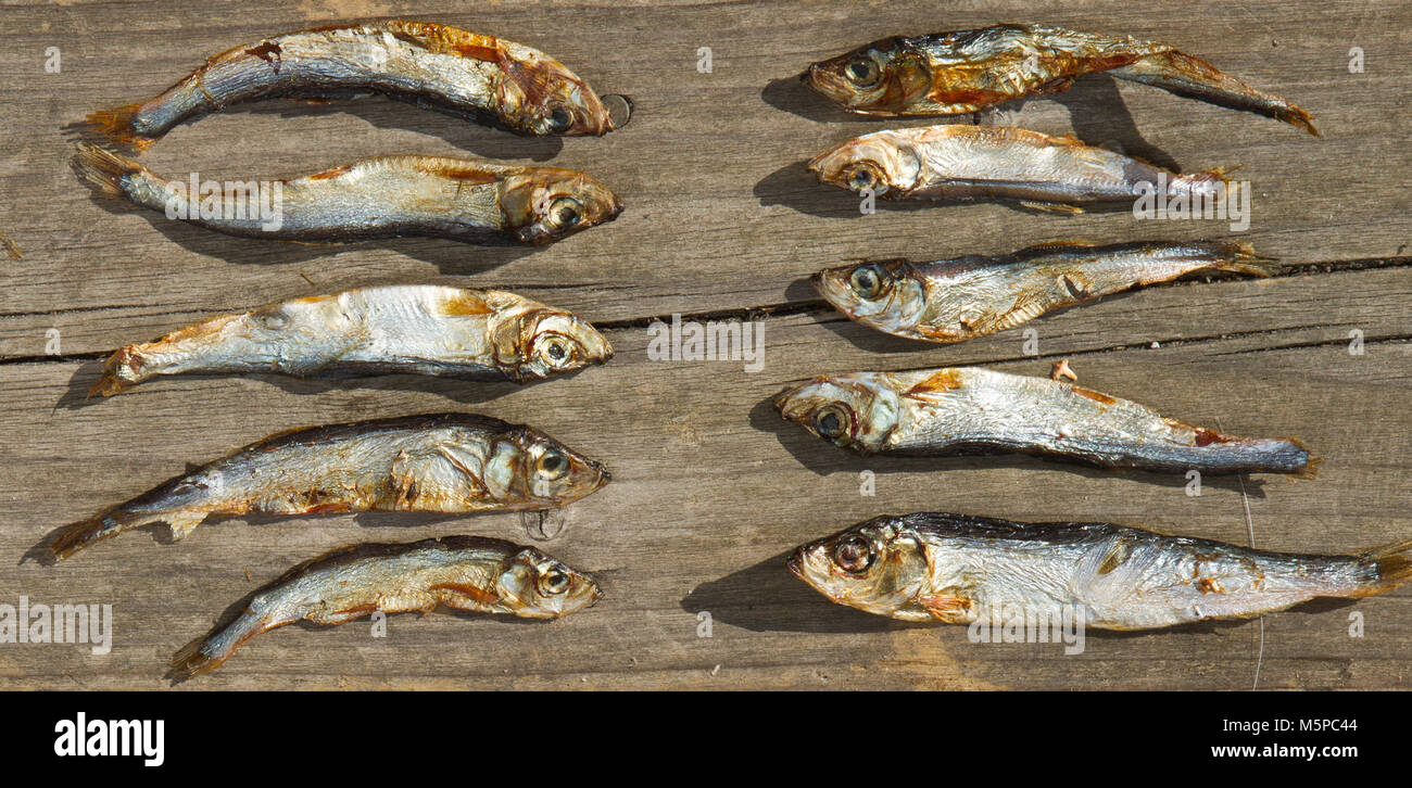 Plenty of small dried fishes on a stack Stock Photo
