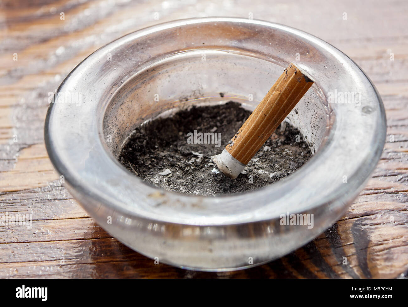 cigarette with ashtray on wood table . Stock Photo