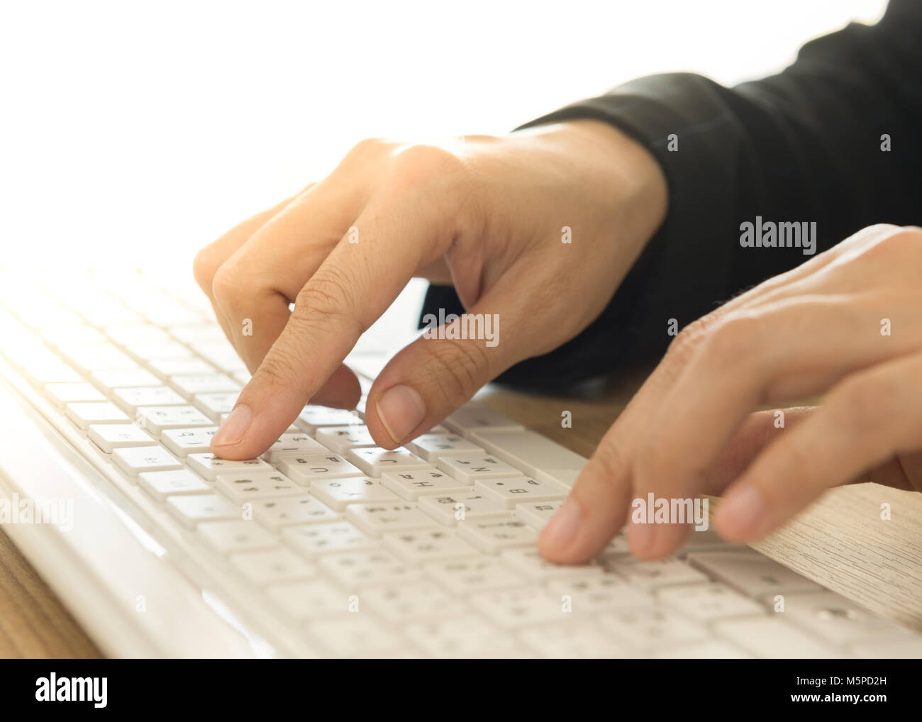 human's hands typing on computer keyboard. selective focus. Stock Photo