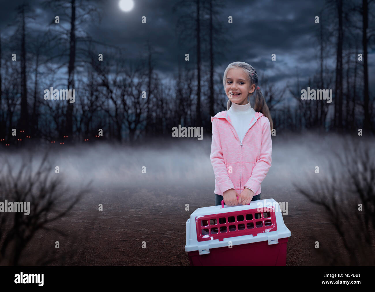 Happy little girl with pink carrier in the forest at night Stock Photo ...